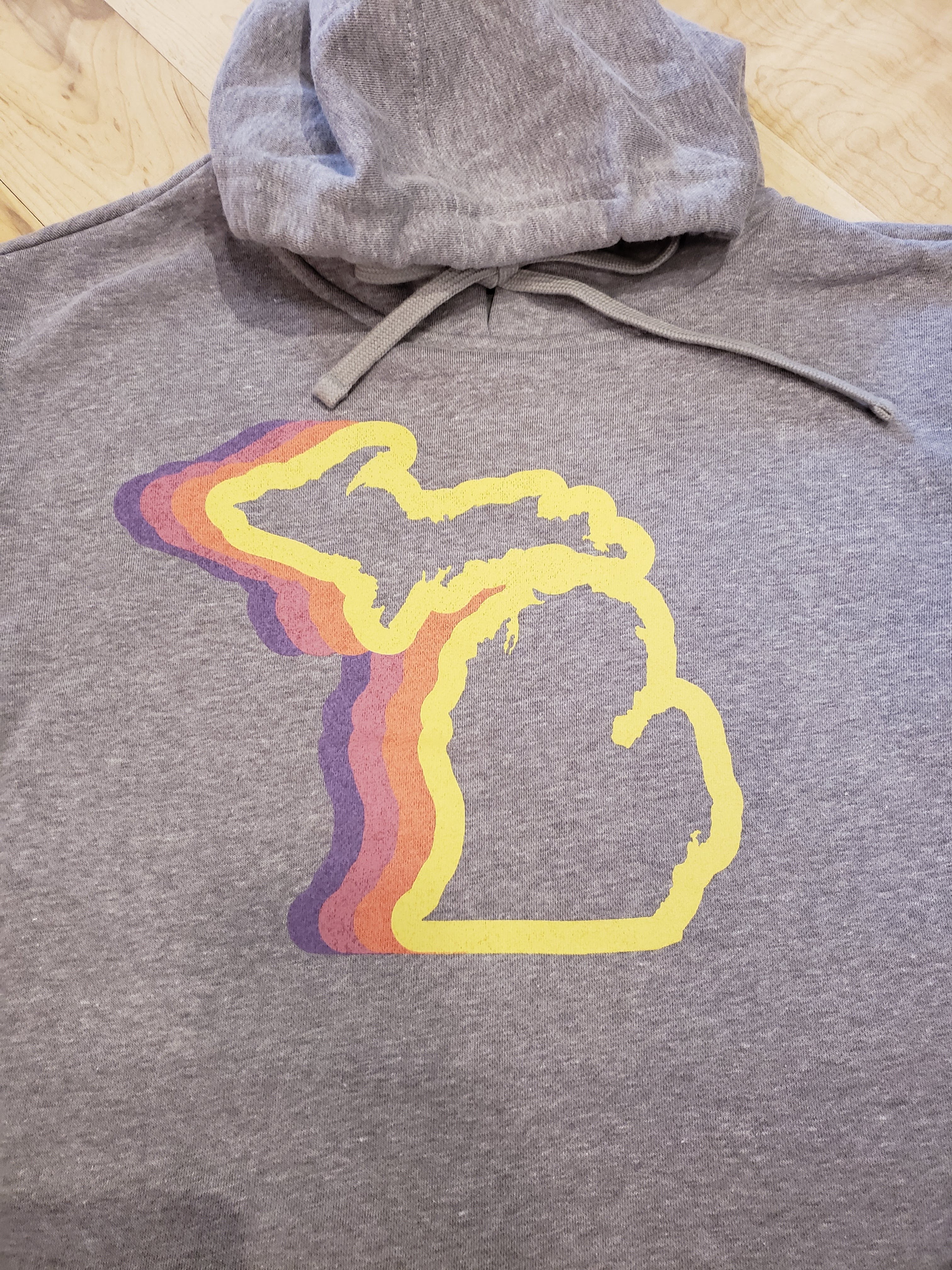 Michigan 70's Women's Pullover Hoodie in athletic gray - Front graphic has a color wave outline of the State of Michigan